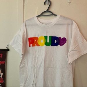 Vintage white 100% cotton shirt-sleeve pride tee with “PROUD” rainbow graphic